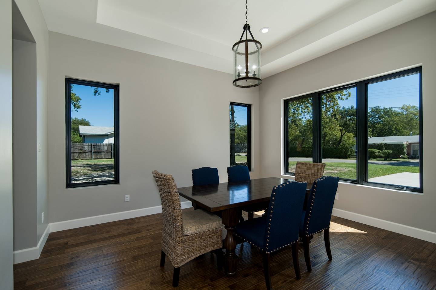 100 Series Casement Windows — black picture and casement windows in a dining room