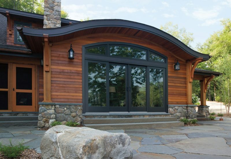 andersen-a-series-ellipsis-black-window-and-four-panel-sliding-patio-door-and-wood-siding