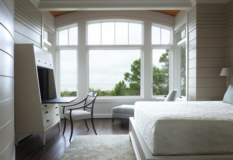 white-woodclad-arched-windows-in-a-guest-bedroom